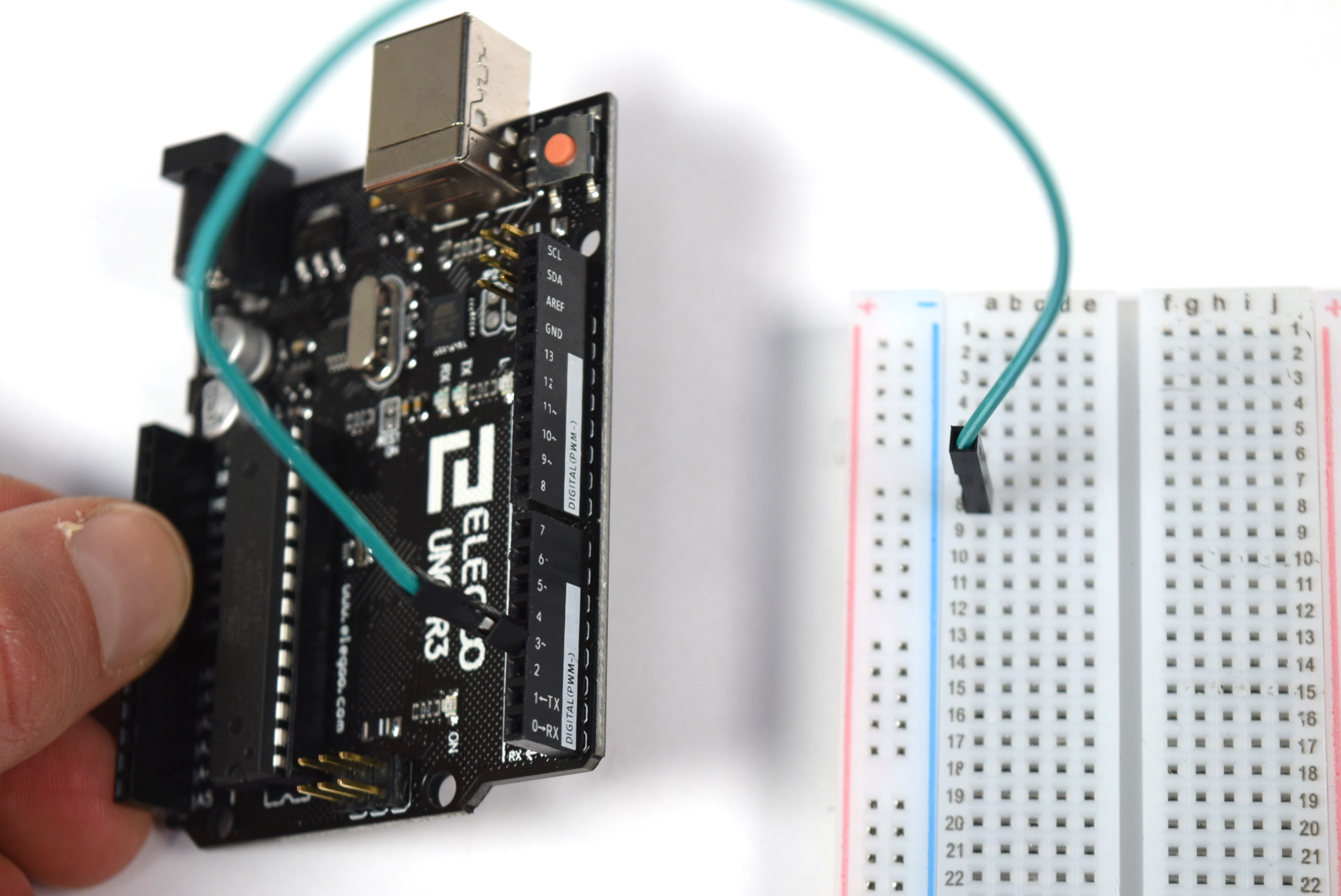 Photograph of a jumper going from Arduino pin 3 to position A8 on a medium sized breadboard