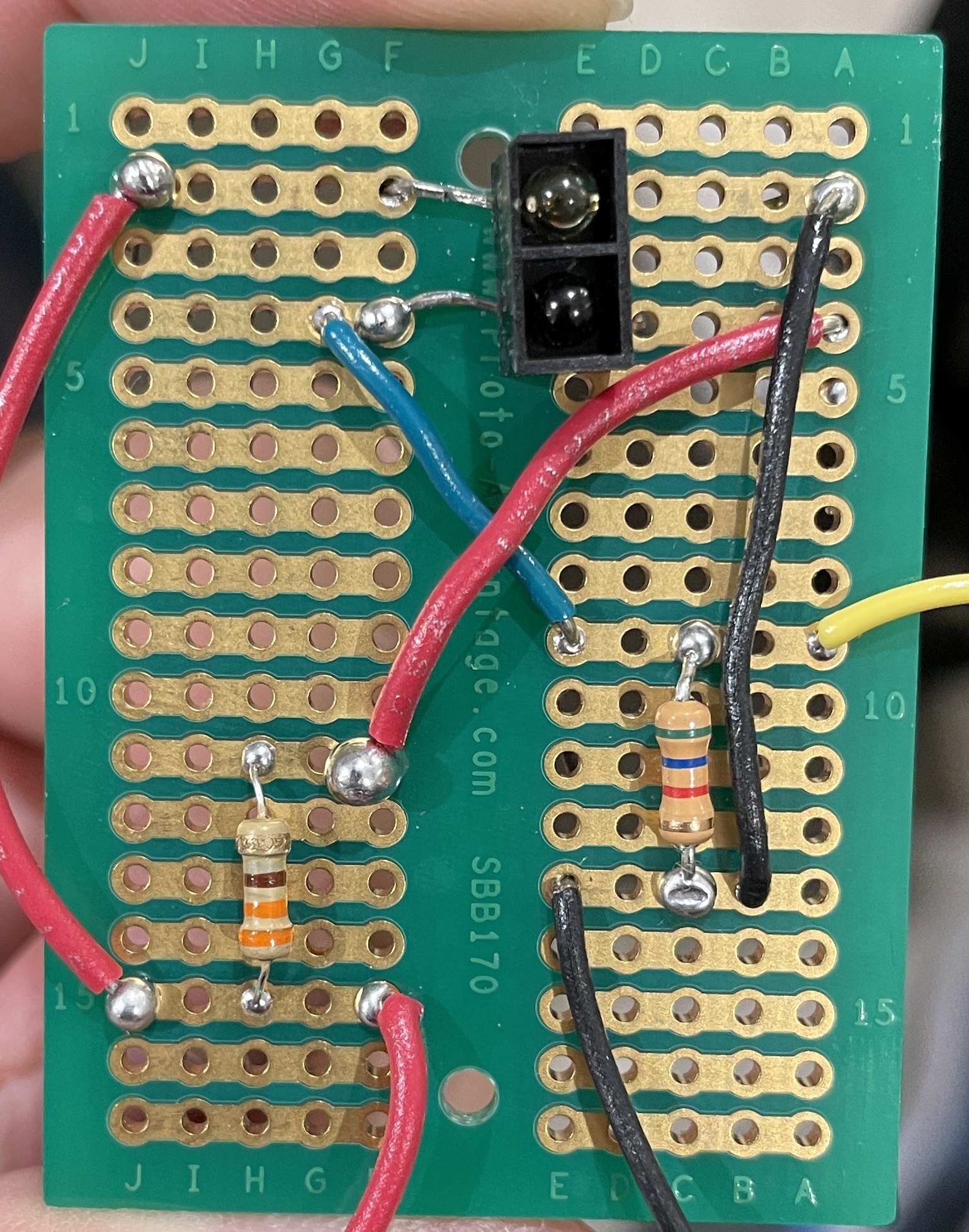 A protoboard with a faulty circuit soldered onto it which led to short-circuiting.