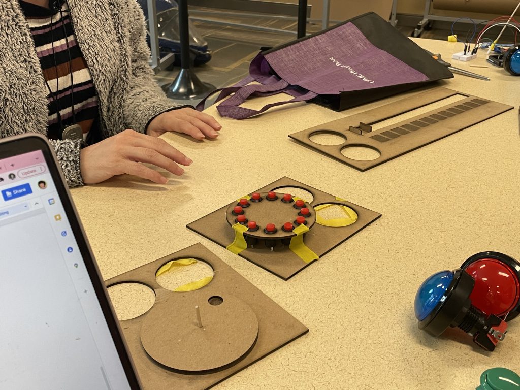 We have 3 different prototypes on the table. The leftmost prototype is based on a rotatry dial clock, the middle is made of buttons arranged in a circle, and the rightmost prototype is based on a slider mechanism