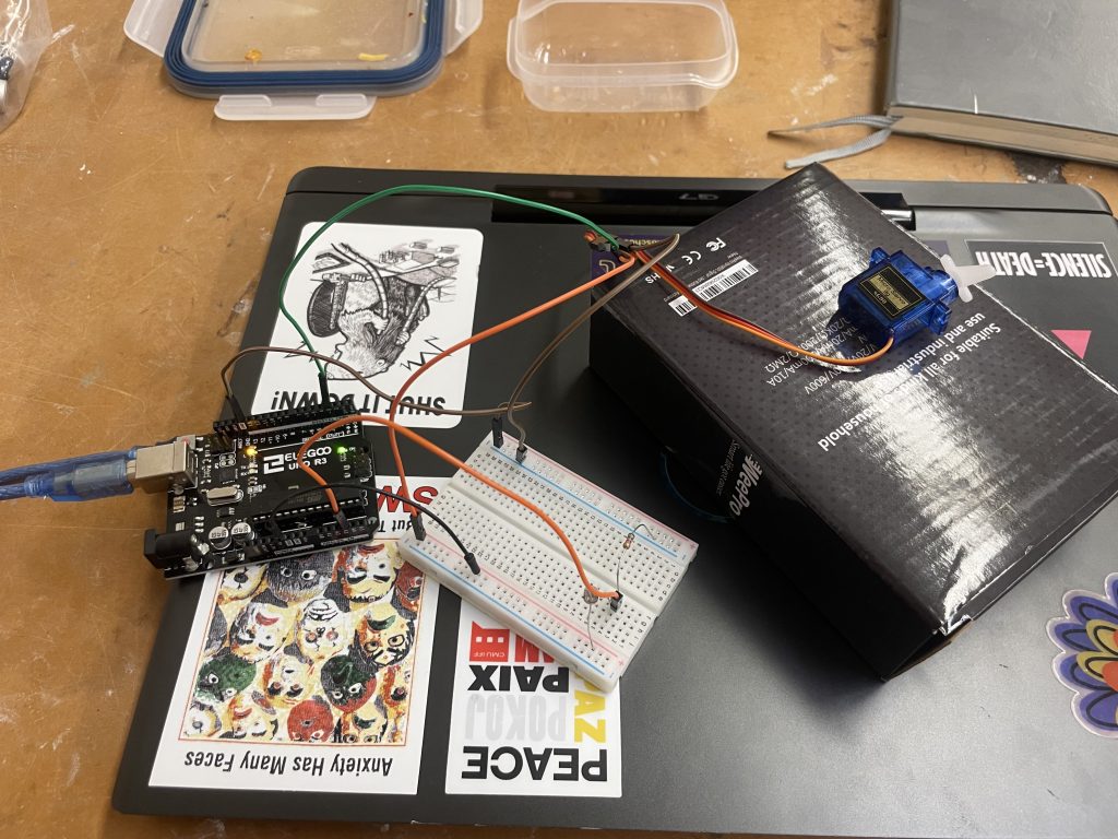 Image of a breadboard connecting an arduino to a servo motor.