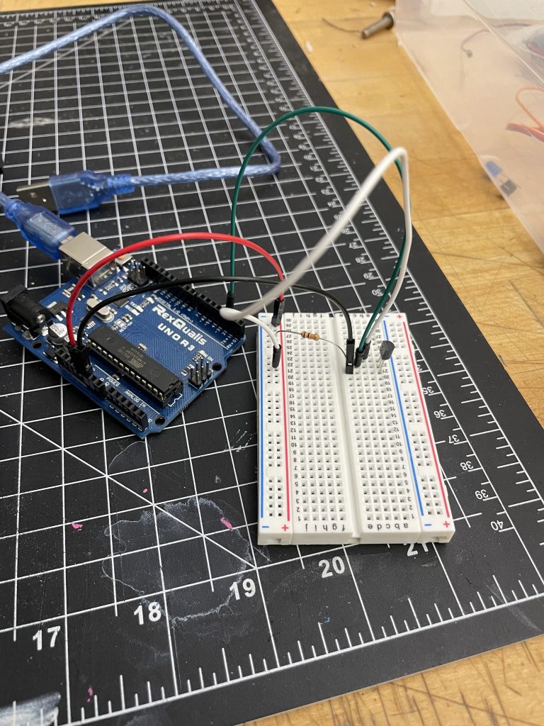 picture of Arduino to breadboard wired up to a thermometer 