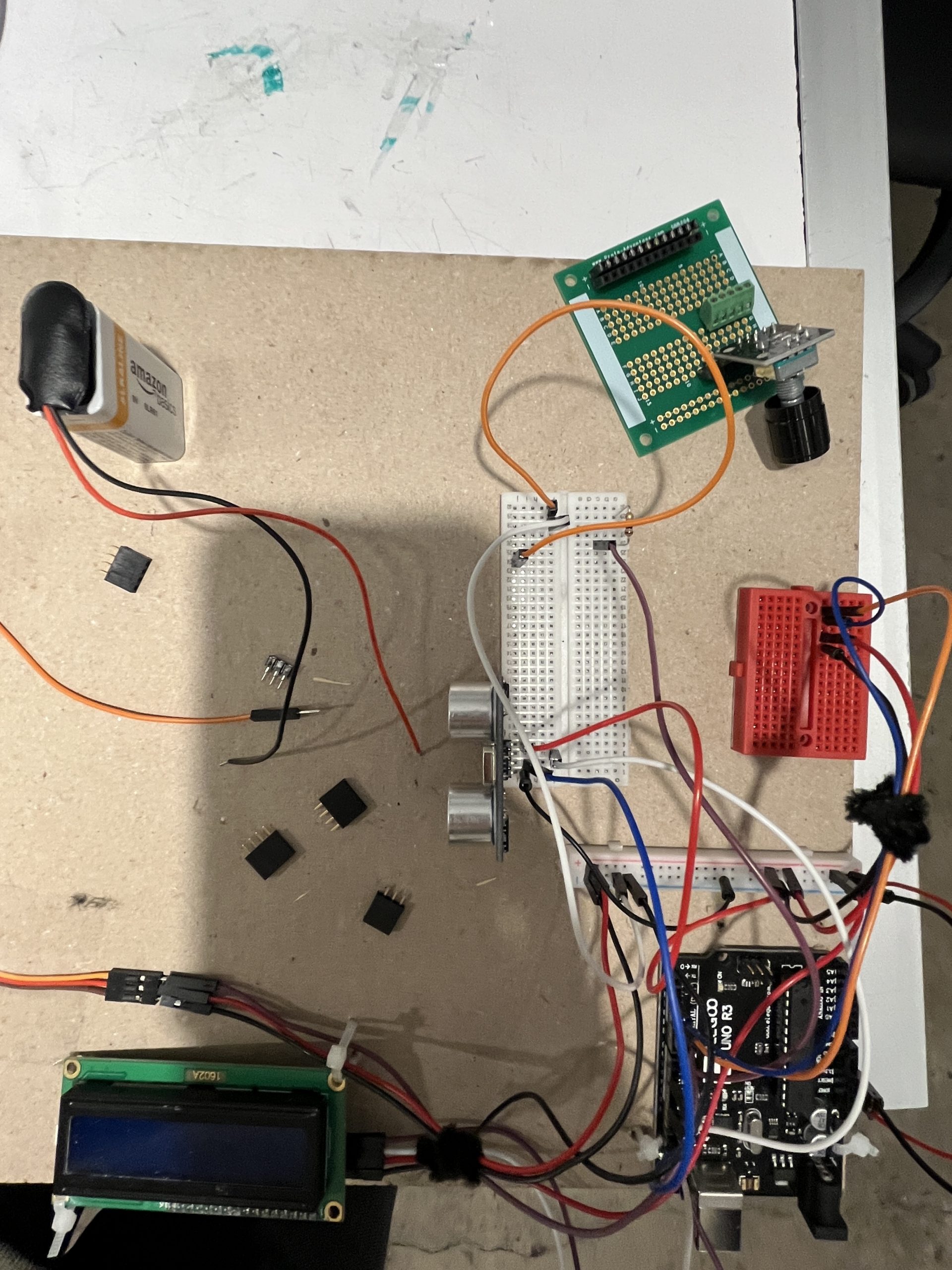 A mess of breadboards, wires, and components on a chipboard. There are a few transistors scattered and a lot of the wires are unplugged.