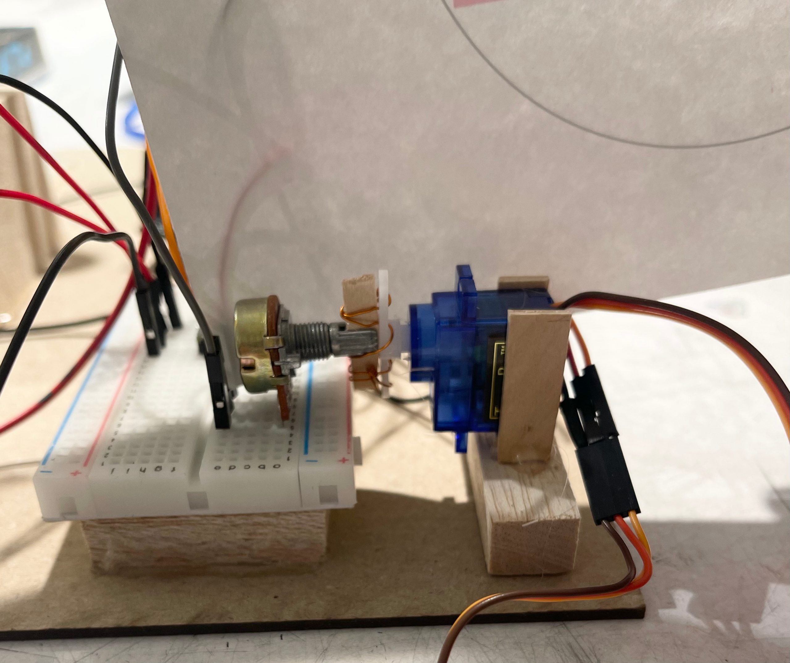 Servo motor attached to potentiometer with wires.
