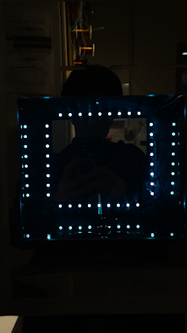 Frontview of the fountain with frame rate of camera matched such that the "backwards flow effect" occurs and droplets (illuminated light blue) look to fall upwards.