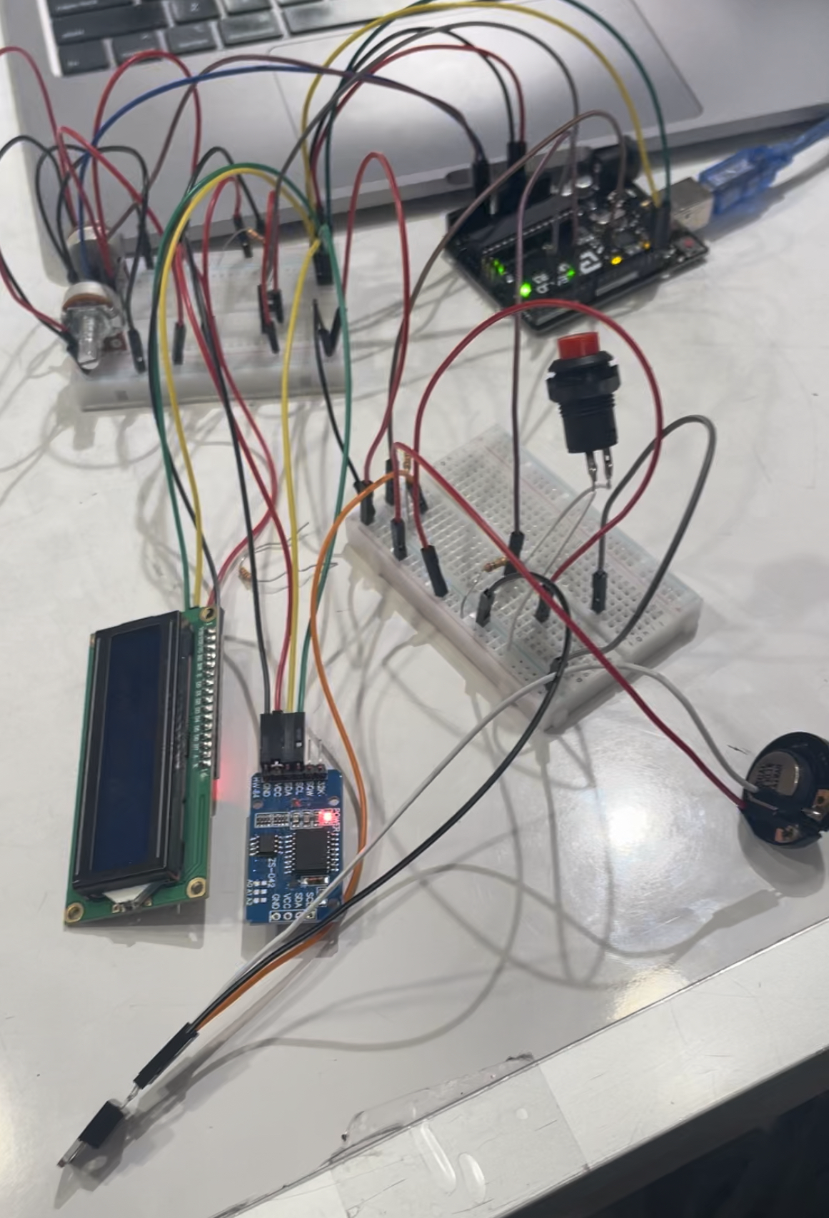 RTC module, speaker, Arduino, potentiometers, LCD Screen, and buttons connected through a breadboard