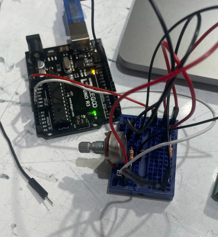 a small breadboard with wires linking to an arduino