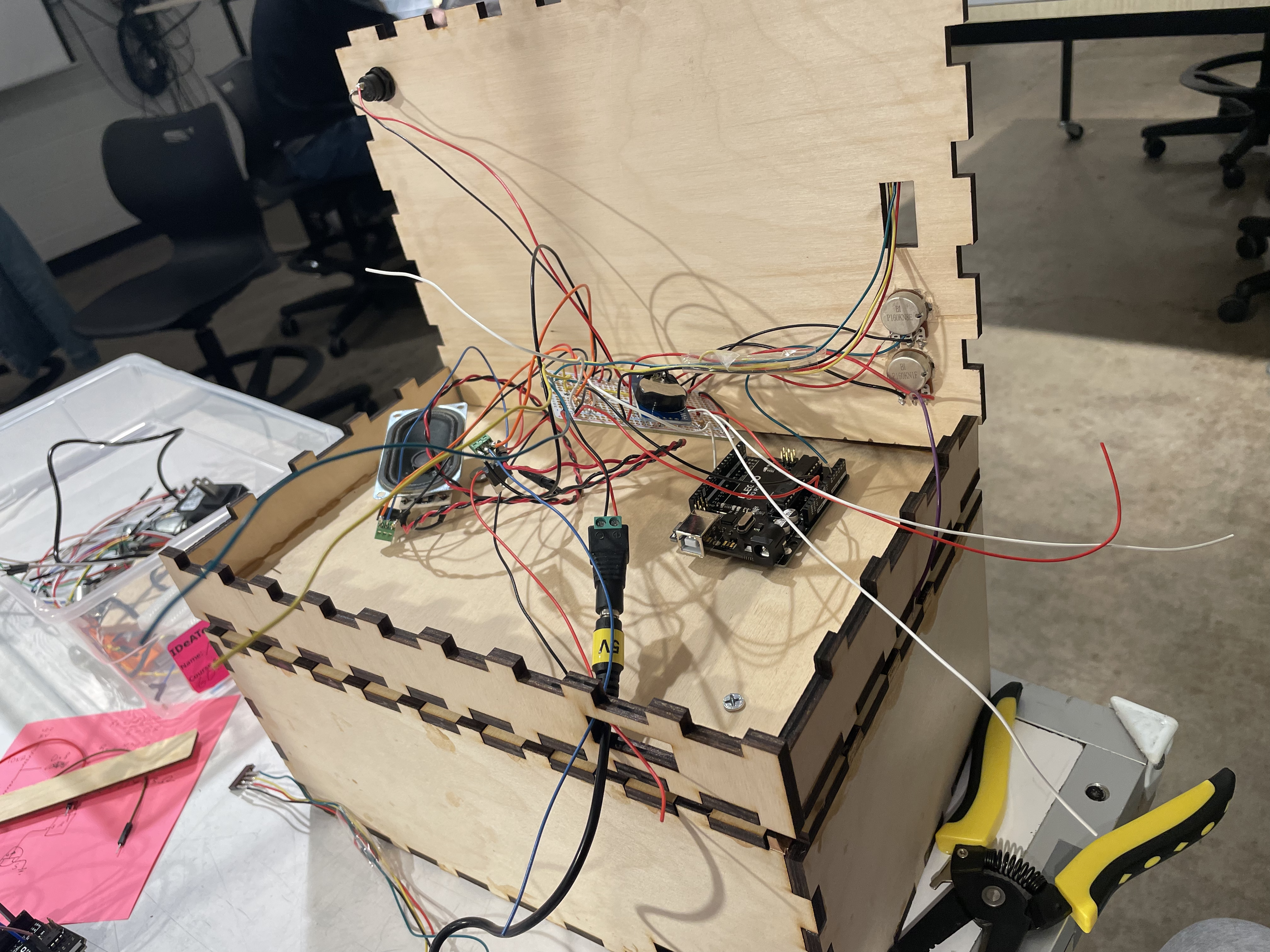 Open box with wires running from Arduino to separate electronics