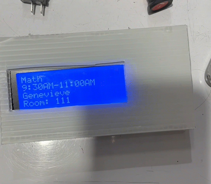 White box with blue lcd screen changing text every few seconds