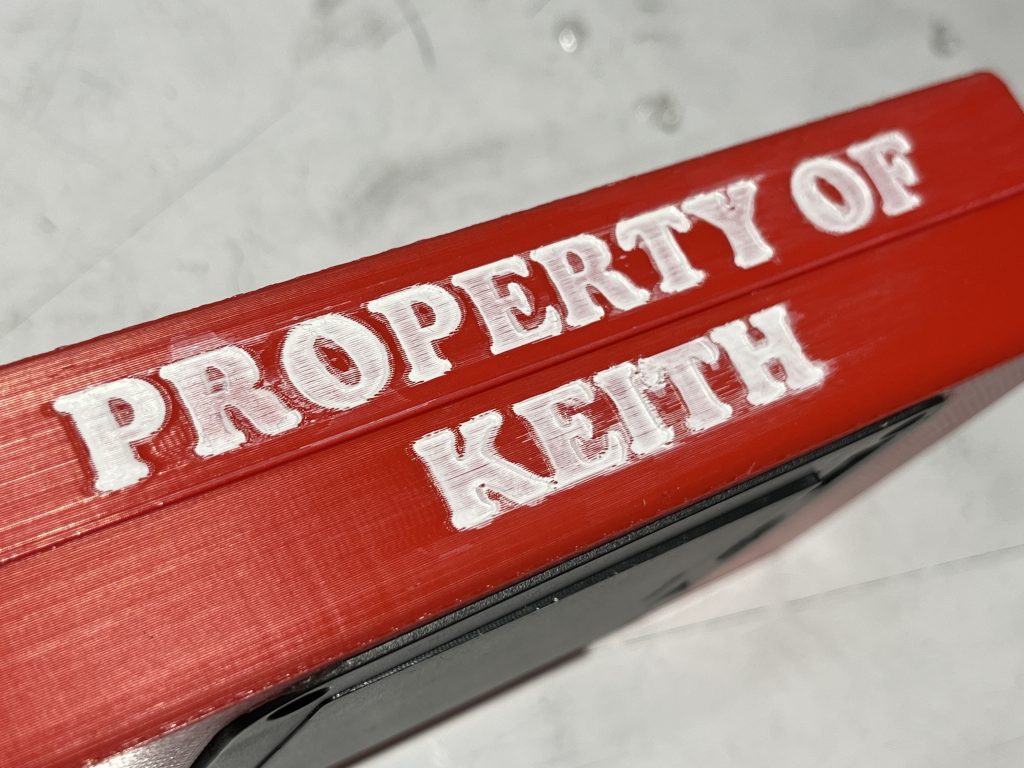 Red box turned to the long side revealing white text that reads "Property of Keith"