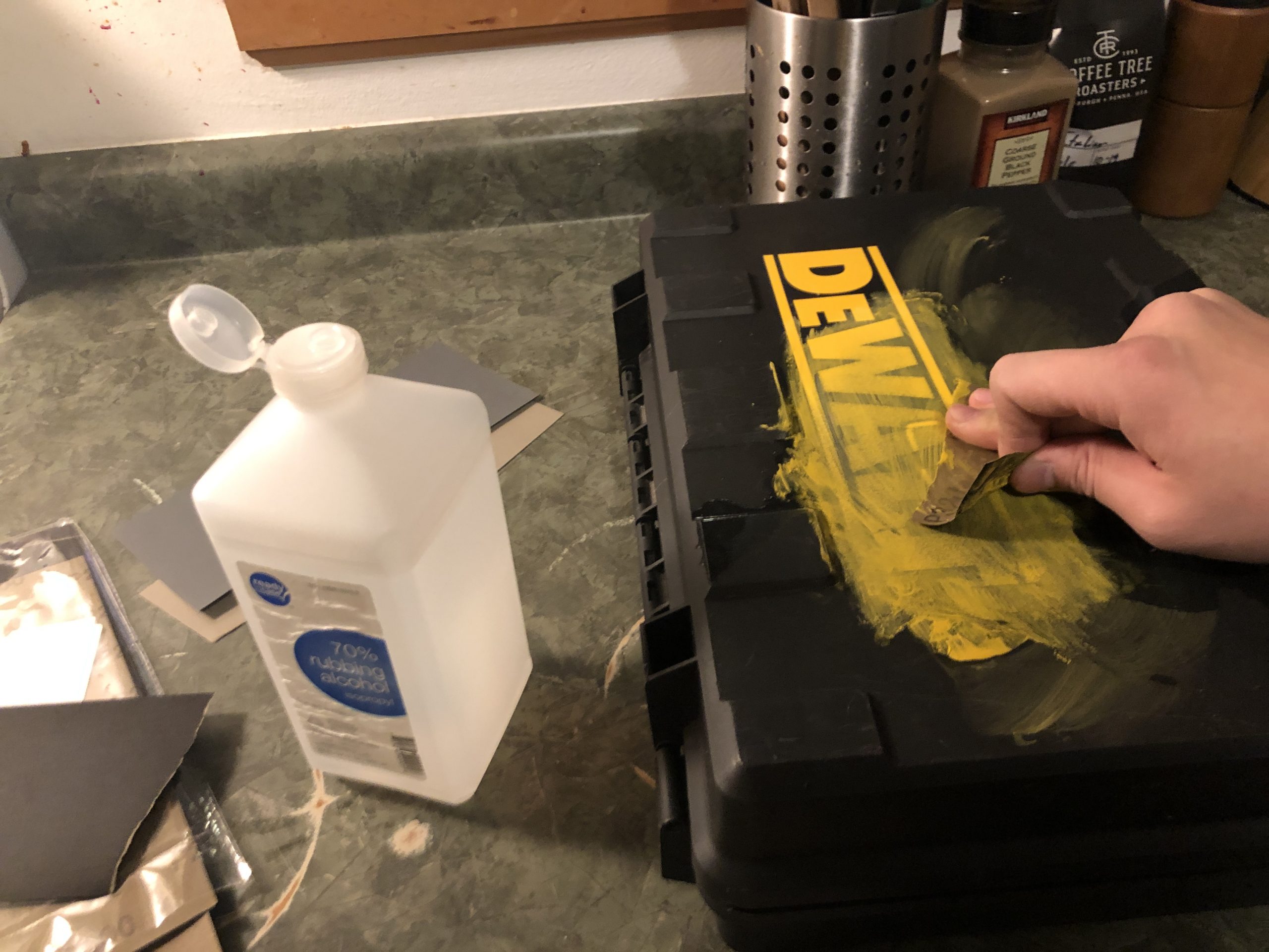 Removing the DeWalt logo using sandpaper. I should've used acetone, it would have been much faster