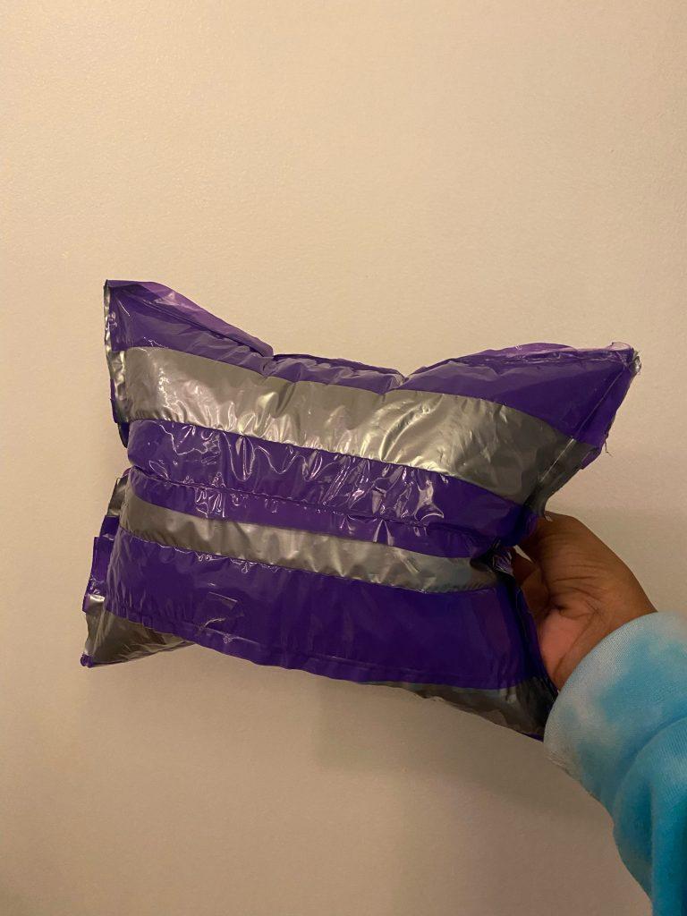purple and silver inflatable with seams on the outside - shaped like ap pillow